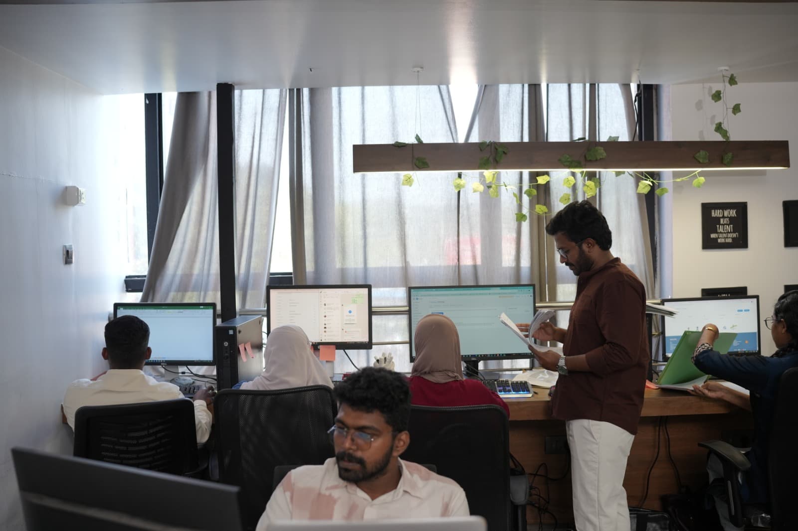 Pelago team collaborating at shared desks in HiLITE Business Park