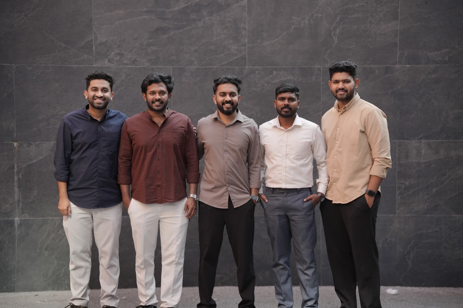 Pelago leadership team group portrait — five founders in business casual at HiLITE Business Park